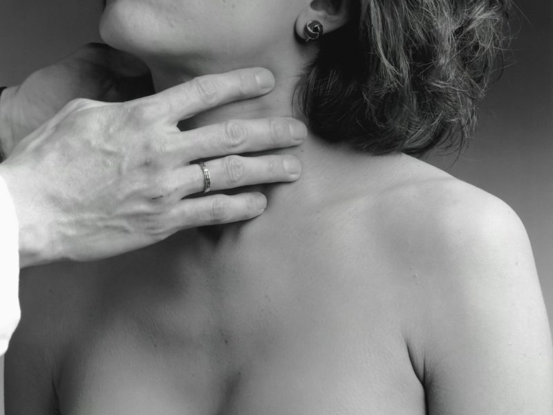 a woman has her hand on the shoulder of a man